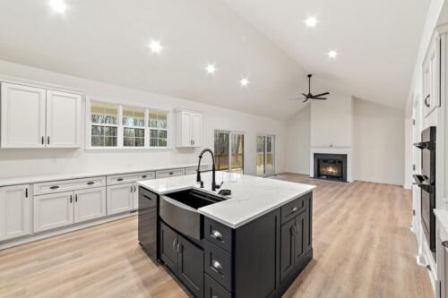 Caliber Home Builder, Ashwood II kitchen island and open dining room with fireplace