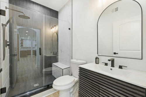 The Corbisiero - luxurious full bathroom with walk-in shower, by Caliber Homebuilder