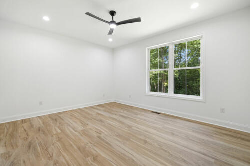 The Corbisiero - first floor bedroom with hardwood floor, by Caliber Homebuilder