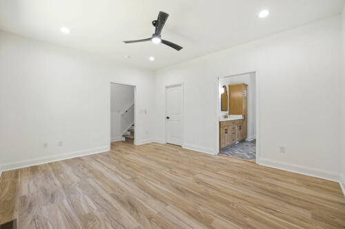 The Corbisiero - first floor bedroom with hardwood floor, by Caliber Homebuilder