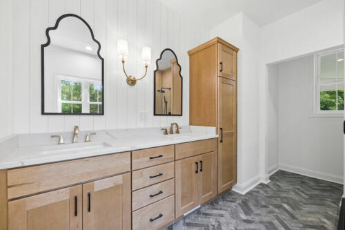 The Corbisiero - elegant full bathroom with natural wood cabinets, by Caliber Homebuilder