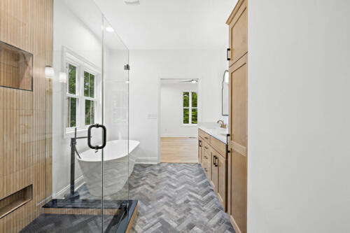 The Corbisiero - elegant full bathroom with walk-in shower and porcelain tub, by Caliber Homebuilder