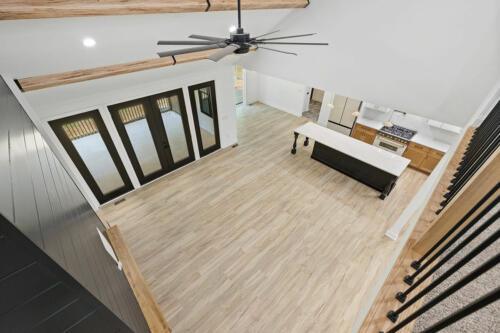 The Corbisiero - view of main living area and kitchen from second floor mezzanine, by Caliber Homebuilder