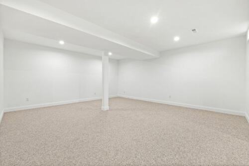 The Corbisiero - large finished basement with carpet floor, by Caliber Homebuilder
