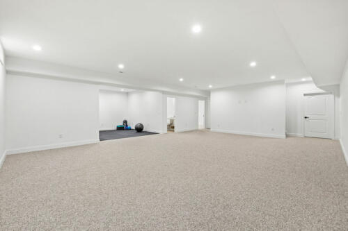The Corbisiero - large finished basement with workout area, by Caliber Homebuilder