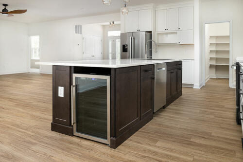 Caliber Home Builder, The Hart, Kitchen island with a wine fridge