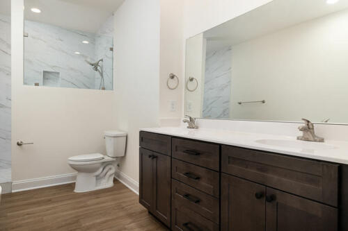Caliber Home Builder, The Hart, bathroom with a double vanity, and large shower