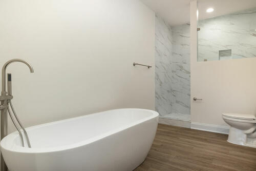 Caliber Home Builder, The Hart, bathroom bathtub and large walk-in shower